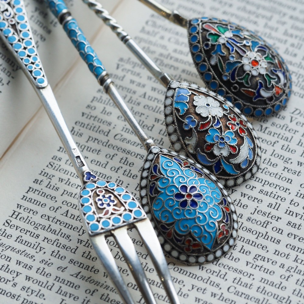 A four-piece set of late 19th-century Russian silver and cloisonne enamel cutlery featuring three spoons and a fork with turquoise blue, white, and red floral motifs. View XI