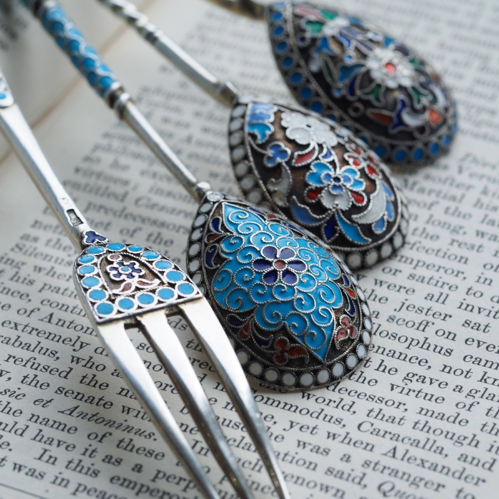 A four-piece set of late 19th-century Russian silver and cloisonne enamel cutlery featuring three spoons and a fork with turquoise blue, white, and red floral motifs. View XII