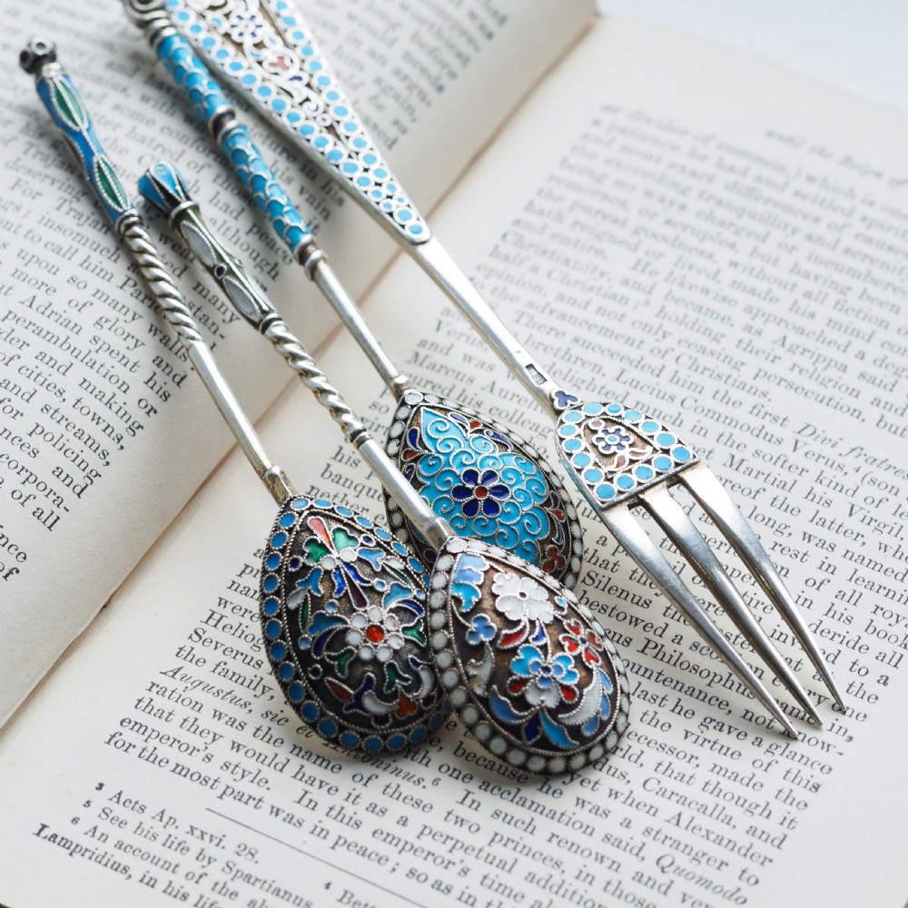 A four-piece set of late 19th-century Russian silver and cloisonne enamel cutlery featuring three spoons and a fork with turquoise blue, white, and red floral motifs. View XIV