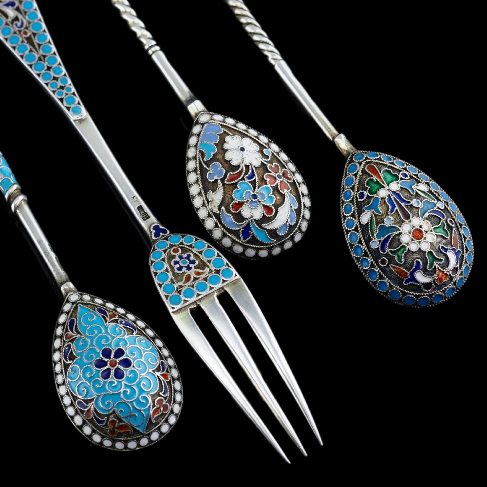 A four-piece set of late 19th-century Russian silver and cloisonne enamel cutlery featuring three spoons and a fork with turquoise blue, white, and red floral motifs. View XVII