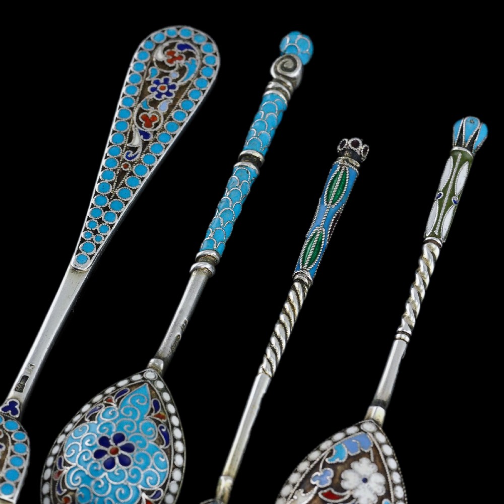 A four-piece set of late 19th-century Russian silver and cloisonne enamel cutlery featuring three spoons and a fork with turquoise blue, white, and red floral motifs. View XVIII