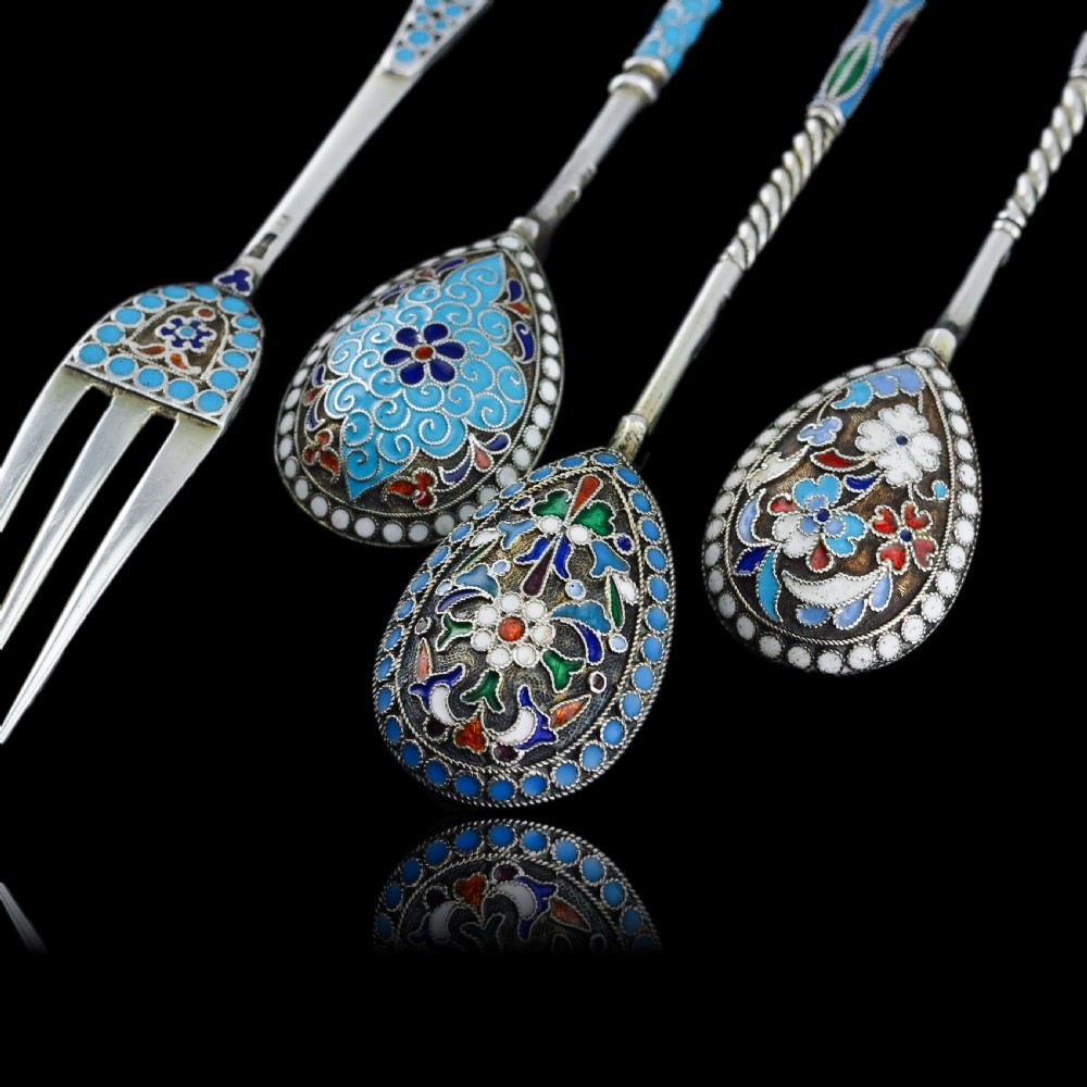 A four-piece set of late 19th-century Russian silver and cloisonne enamel cutlery featuring three spoons and a fork with turquoise blue, white, and red floral motifs. View XIX