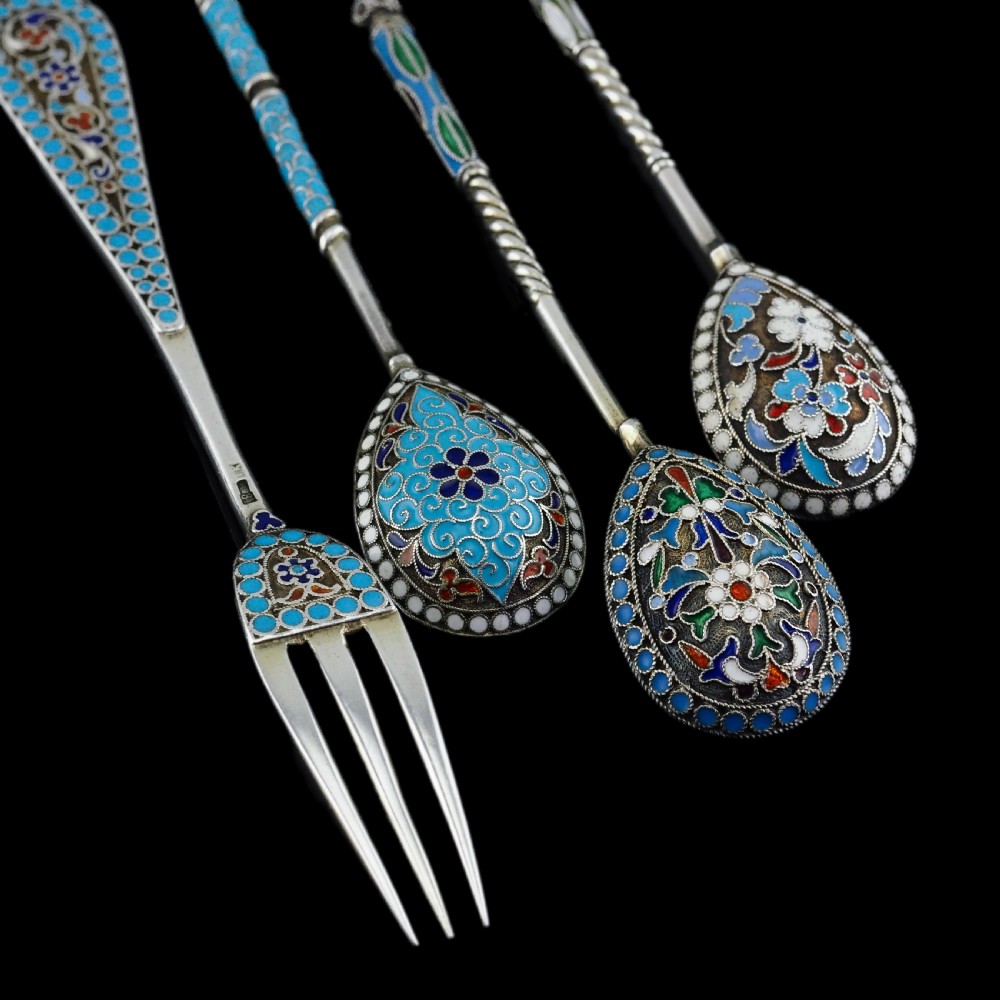 A four-piece set of late 19th-century Russian silver and cloisonne enamel cutlery featuring three spoons and a fork with turquoise blue, white, and red floral motifs. View XX