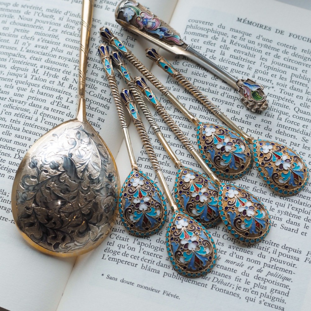 Set of six antique Russian silver gilt spoons featuring blue, red, and white cloisonne enamel scrollwork on the backs of the teardrop-shaped bowls. View VIII