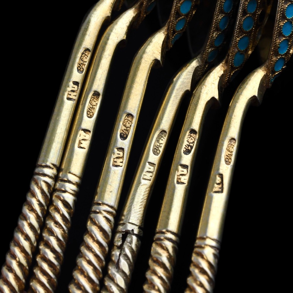 Set of six antique Russian silver gilt spoons featuring blue, red, and white cloisonne enamel scrollwork on the backs of the teardrop-shaped bowls. View XII