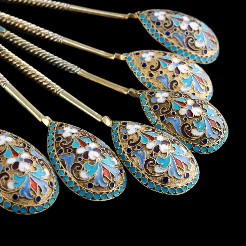 Set of six antique Russian silver gilt spoons featuring blue, red, and white cloisonne enamel scrollwork on the backs of the teardrop-shaped bowls. View XVI