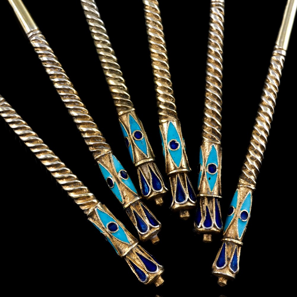 Set of six antique Russian silver gilt spoons featuring blue, red, and white cloisonne enamel scrollwork on the backs of the teardrop-shaped bowls. View XIX