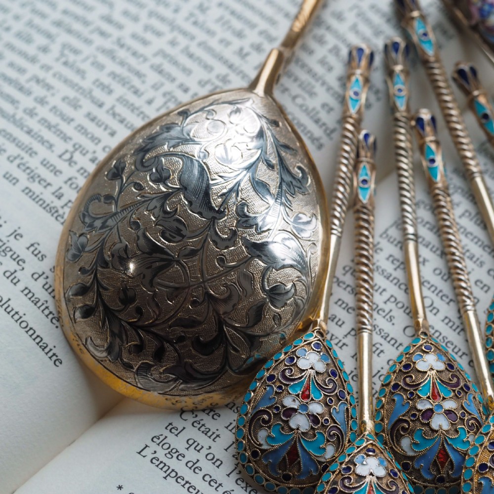 An antique Russian silver-gilt serving spoon featuring intricate black niello foliate engraving across the back of the oval bowl and a turned stem. View X