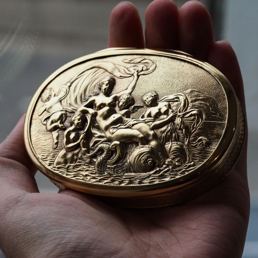 An oval Georgian silver-gilt snuff box featuring a relief scene of Venus surrounded by attendants and sea creatures on the lid. View VI