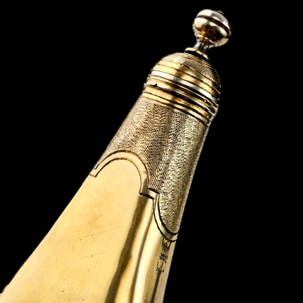 A seventeenth-century teardrop-shaped silver gilt scent flask engraved with a coronet and crest, positioned alongside its dark leather case. View XXIII