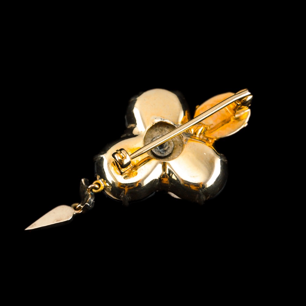 Victorian gold brooch pendant set with four deep red cabochon garnets, a diamond-encrusted insect motif at the centre, and an articulated diamond drop. View V