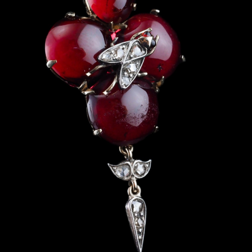 Victorian gold brooch pendant set with four deep red cabochon garnets, a diamond-encrusted insect motif at the centre, and an articulated diamond drop. View XI