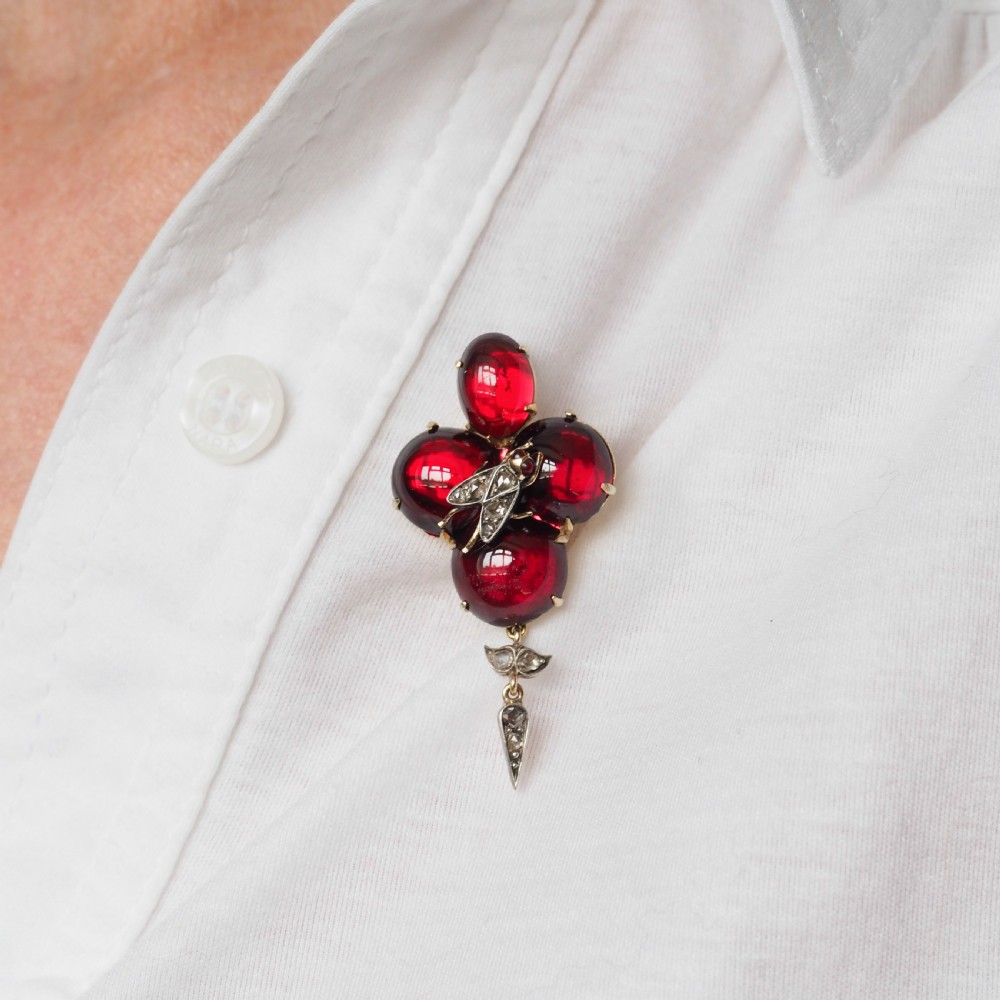 Victorian gold brooch pendant set with four deep red cabochon garnets, a diamond-encrusted insect motif at the centre, and an articulated diamond drop. View XIII