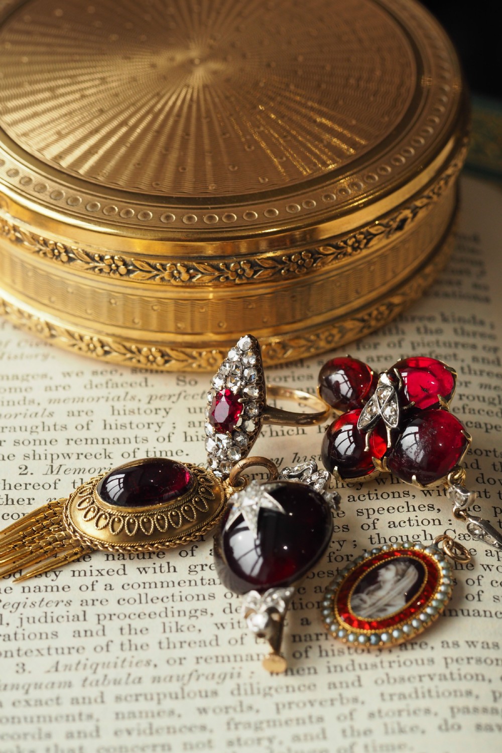 An antique late-nineteenth-century French 18k gold navette cluster ring featuring a central oval red ruby surrounded by multiple rose-cut diamonds. View XX