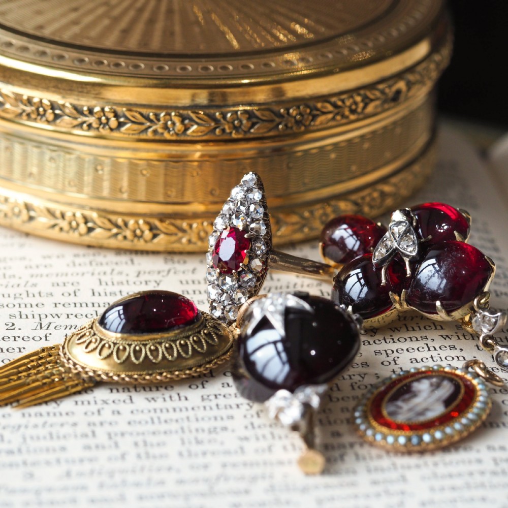 An antique late-nineteenth-century French 18k gold navette cluster ring featuring a central oval red ruby surrounded by multiple rose-cut diamonds. View XXII