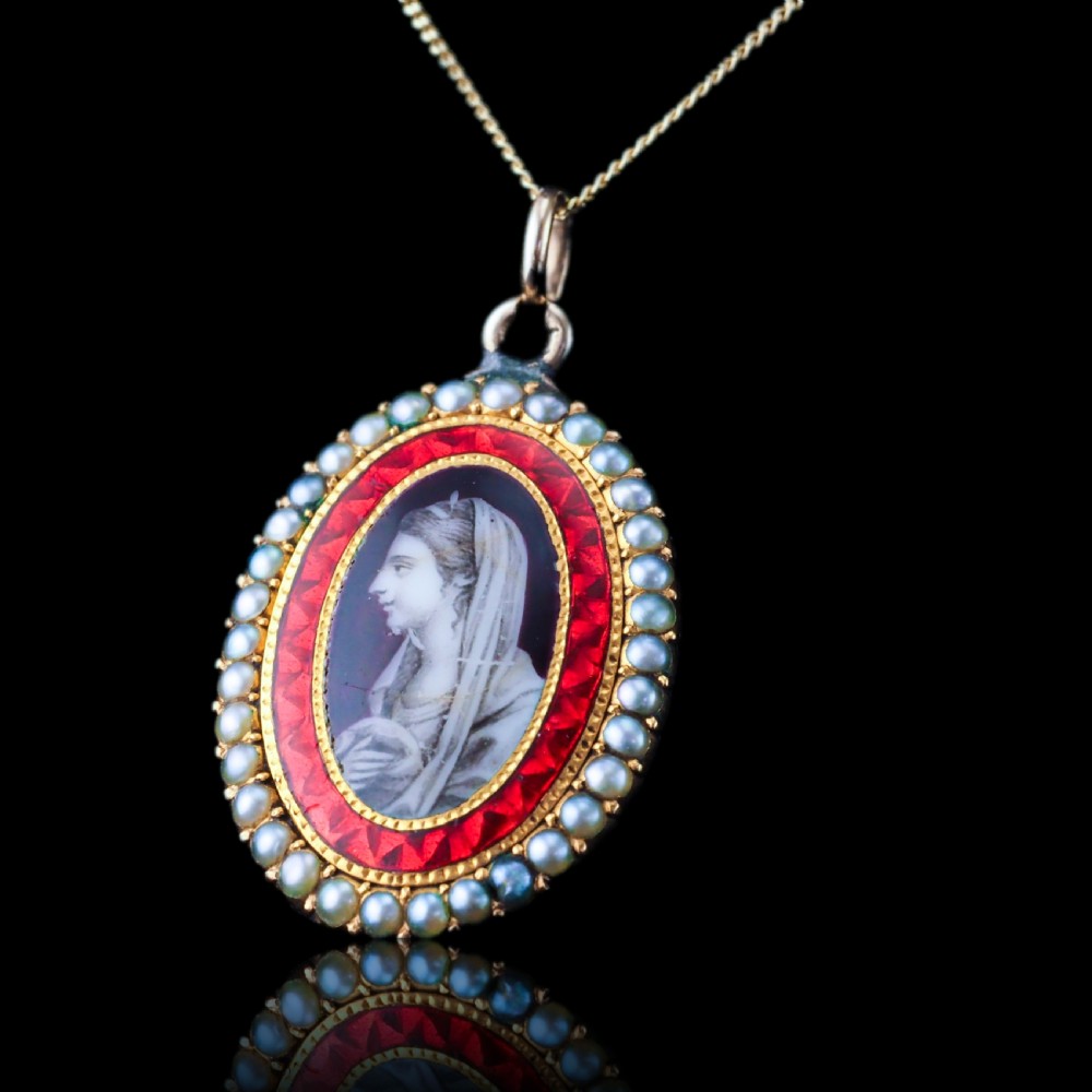 An oval Georgian gold pendant featuring a sepia miniature profile portrait surrounded by a red enamel border and a frame of seed pearls on a fine gold chain. View III