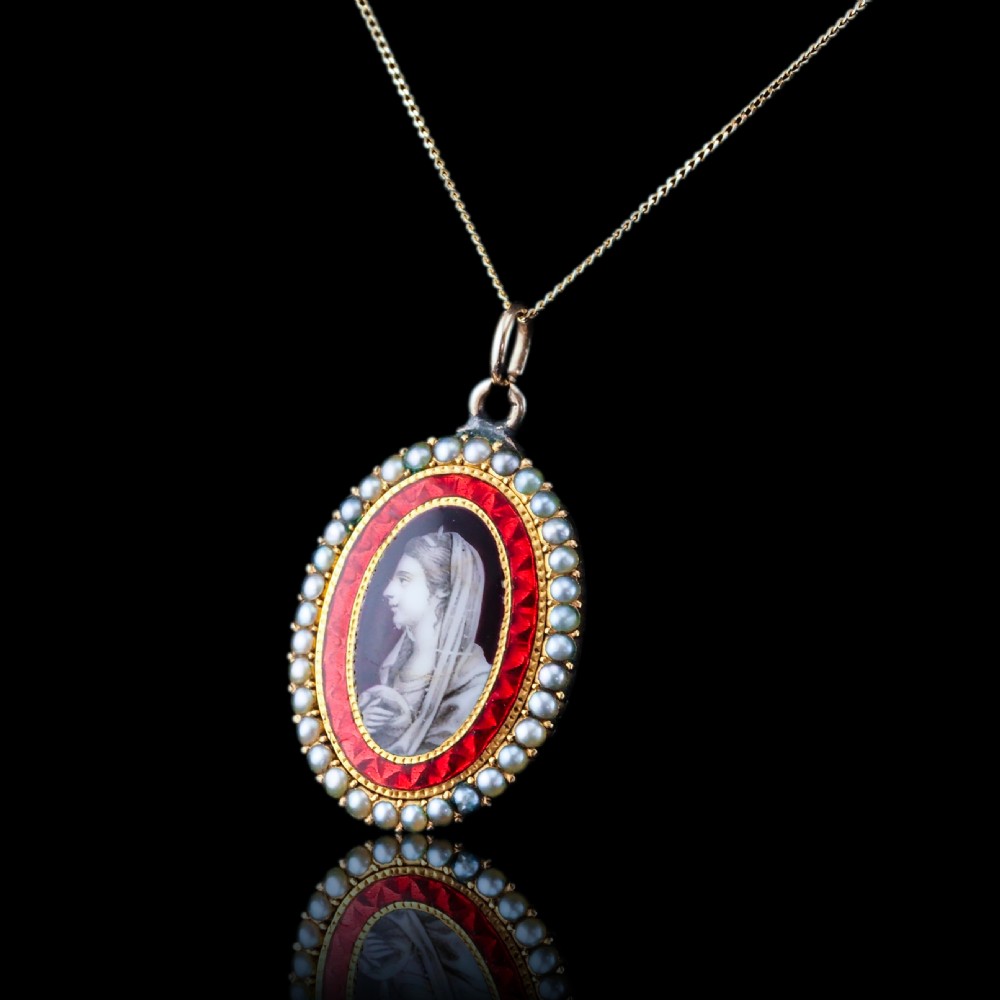 An oval Georgian gold pendant featuring a sepia miniature profile portrait surrounded by a red enamel border and a frame of seed pearls on a fine gold chain. View IV