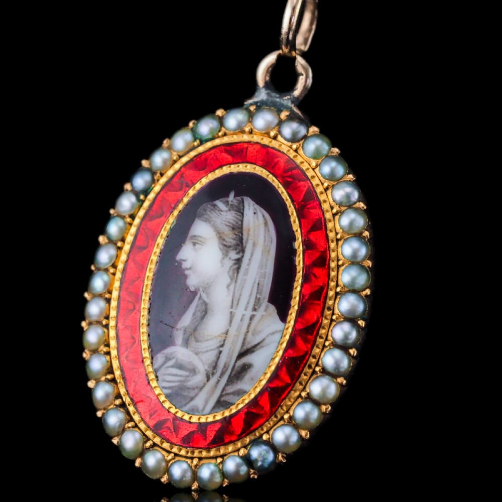 An oval Georgian gold pendant featuring a sepia miniature profile portrait surrounded by a red enamel border and a frame of seed pearls on a fine gold chain. View XIV