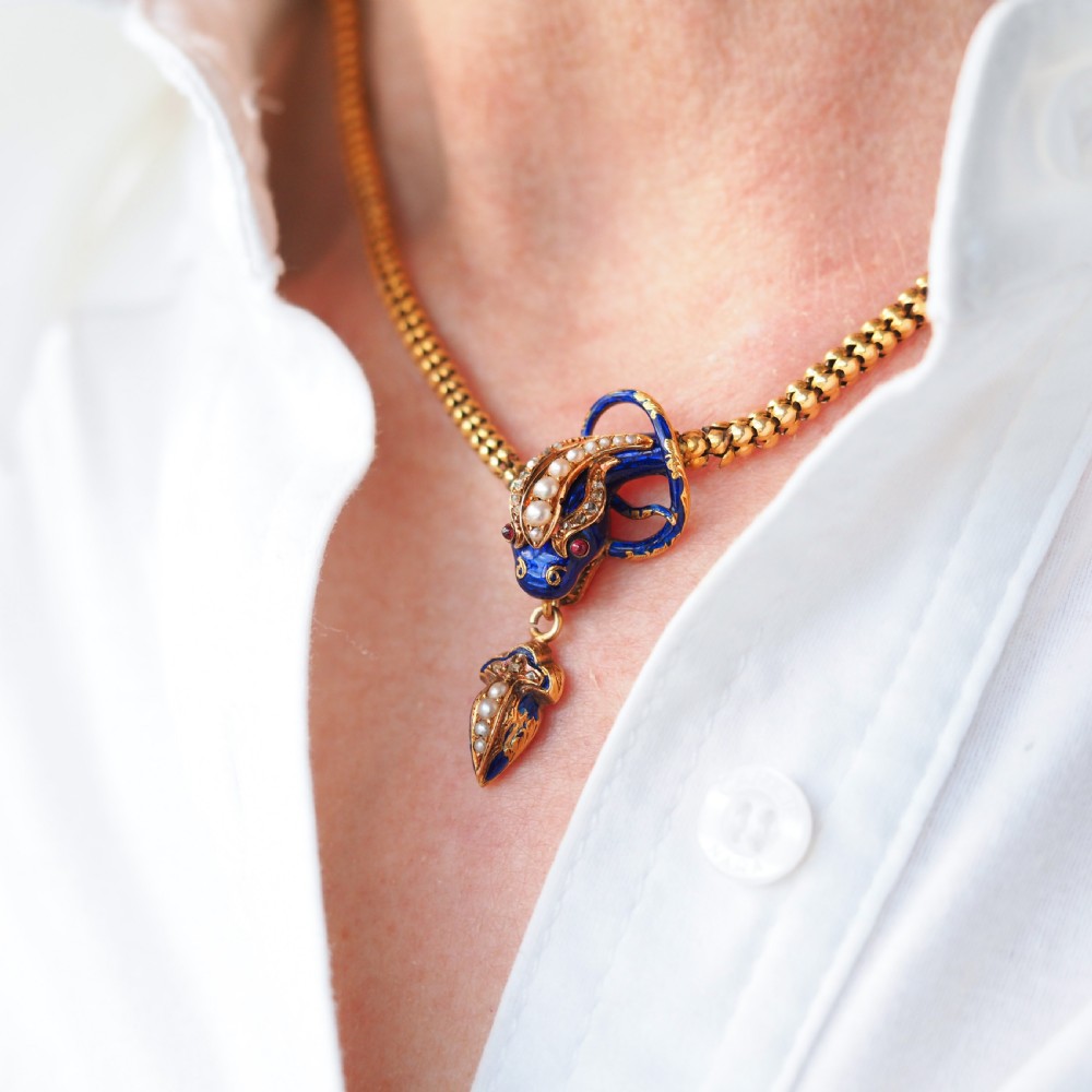 A Victorian 18-carat gold woven chain necklace featuring a blue enamel snake head set with seed pearls, small diamonds, and ruby eyes. View XI