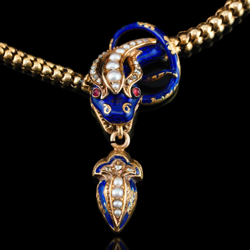 A Victorian 18-carat gold woven chain necklace featuring a blue enamel snake head set with seed pearls, small diamonds, and ruby eyes. View XII