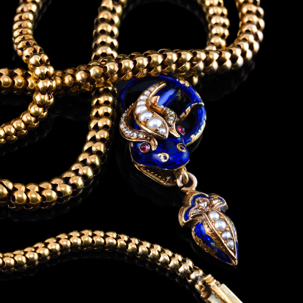 A Victorian 18-carat gold woven chain necklace featuring a blue enamel snake head set with seed pearls, small diamonds, and ruby eyes. View XIII