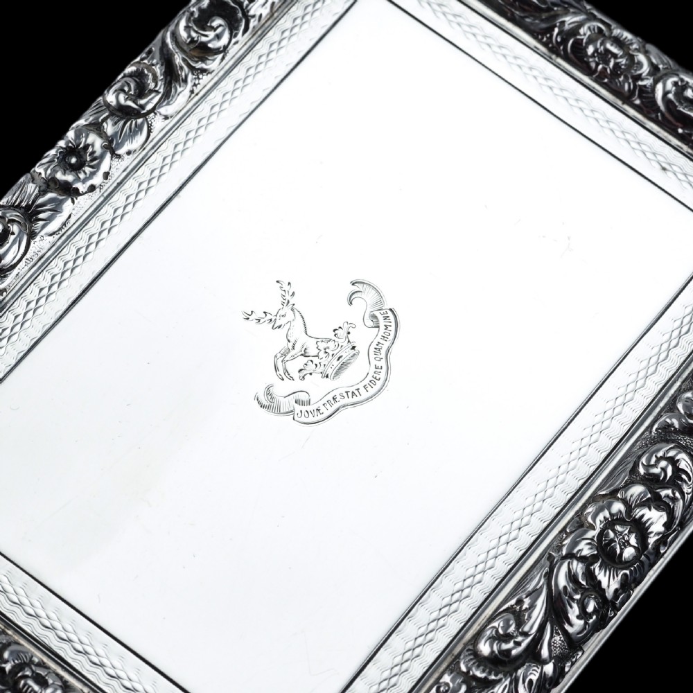 A rectangular sterling silver Georgian snuff box featuring a chased floral border, engine-turned detailing, and a central engraved crest. View XIV