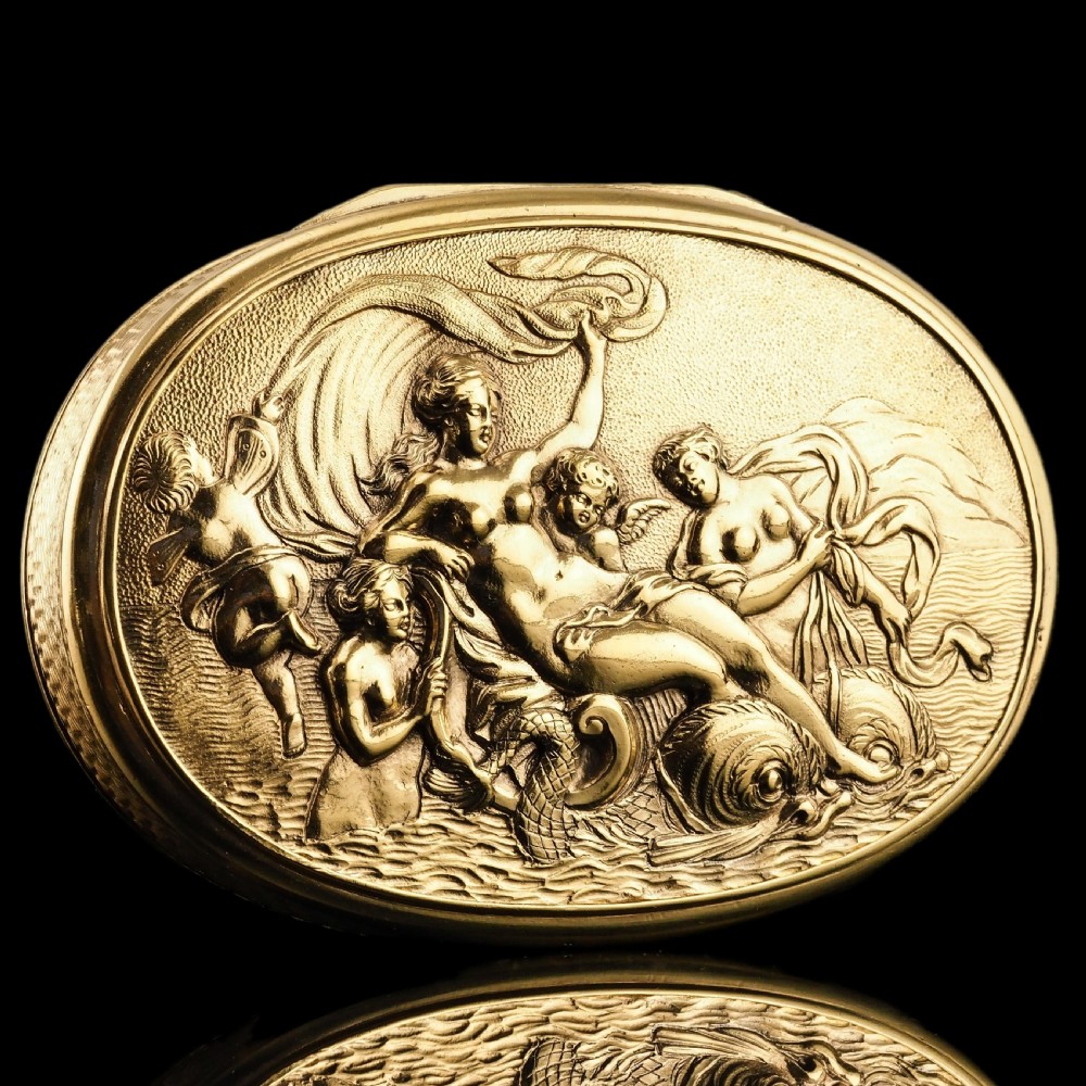 An oval Georgian silver-gilt snuff box featuring a detailed relief depicting Venus surrounded by attendants and cherubs on a textured ground. View II