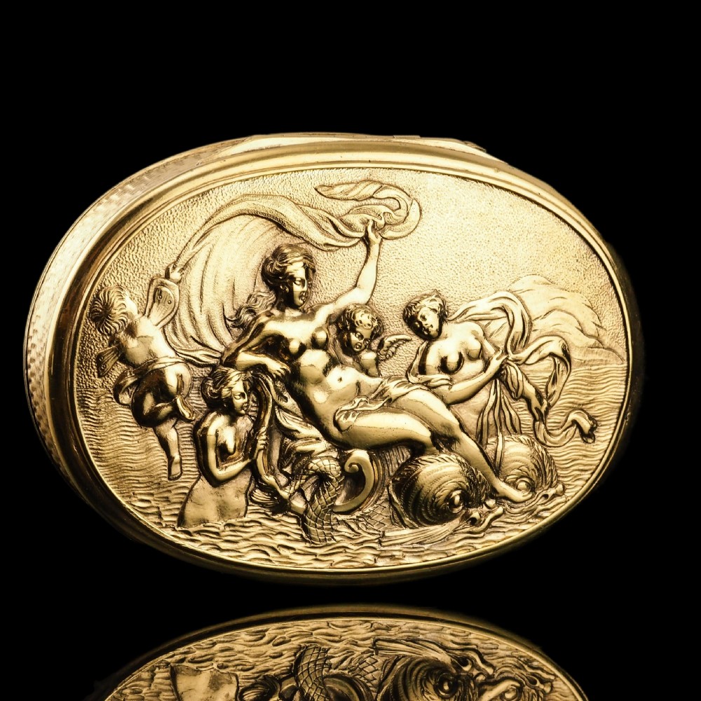 An oval Georgian silver-gilt snuff box featuring a detailed relief depicting Venus surrounded by attendants and cherubs on a textured ground. View IV