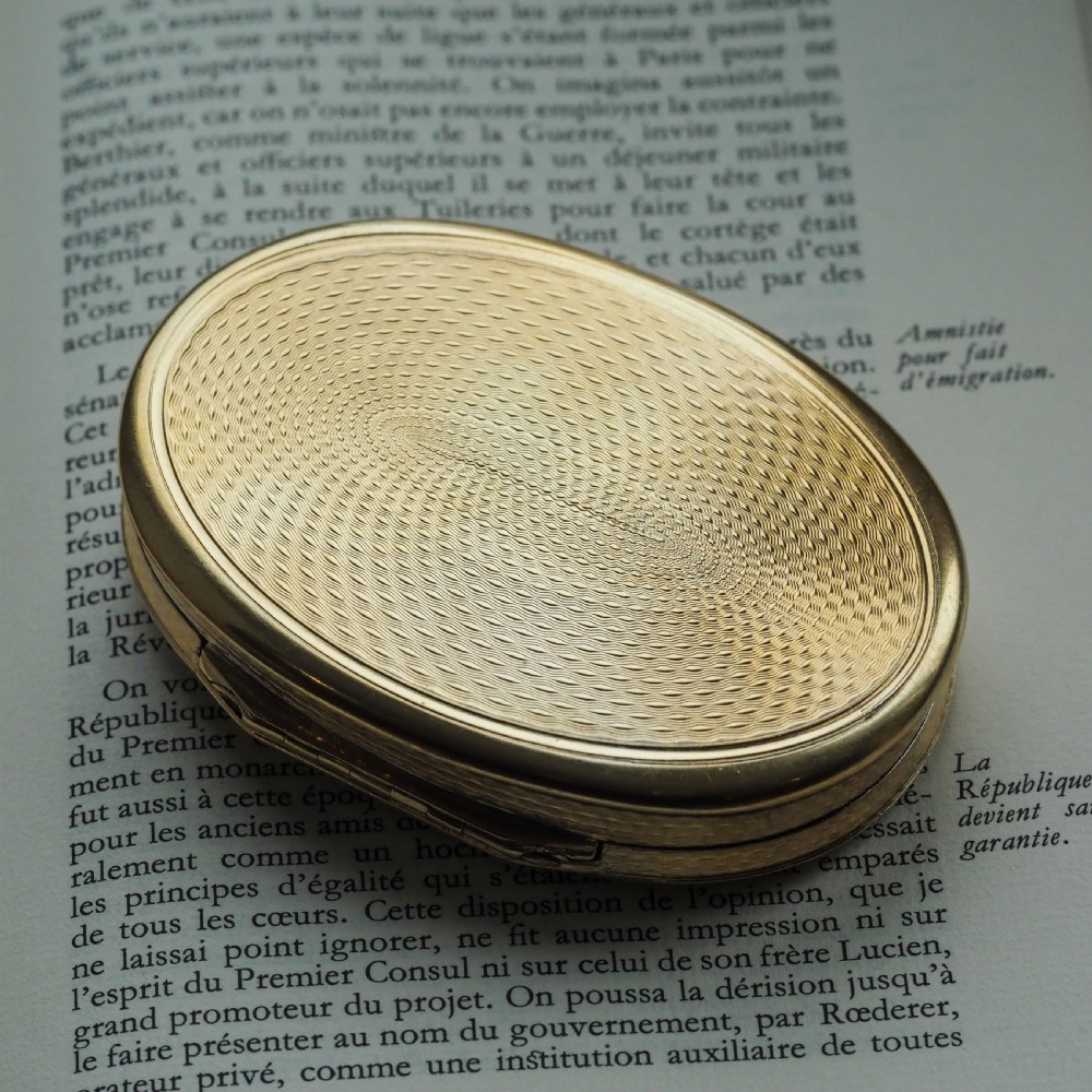 An oval Georgian silver-gilt snuff box featuring a detailed relief depicting Venus surrounded by attendants and cherubs on a textured ground. View VI