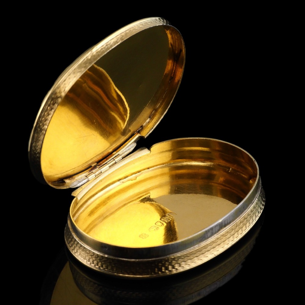 An oval Georgian silver-gilt snuff box featuring a detailed relief depicting Venus surrounded by attendants and cherubs on a textured ground. View XIV