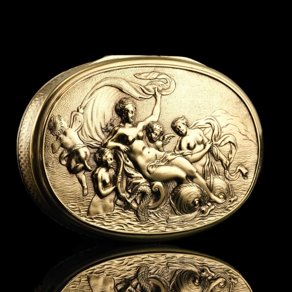 An oval Georgian silver-gilt snuff box featuring a detailed relief depicting Venus surrounded by attendants and cherubs on a textured ground. View XXI
