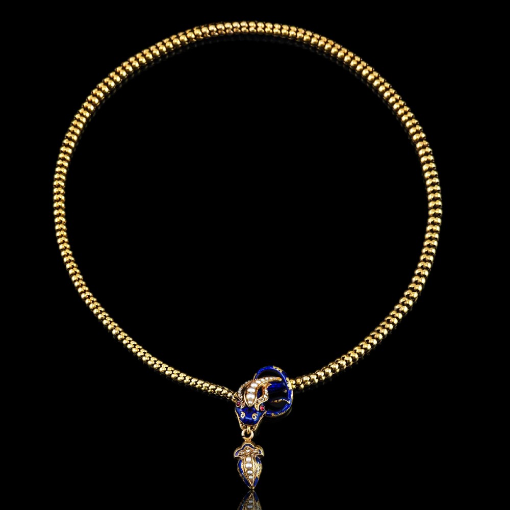 An antique Victorian 18-carat gold snake necklace featuring a flexible chain and a blue enamel serpent head decorated with seed pearls and diamonds. View XIII
