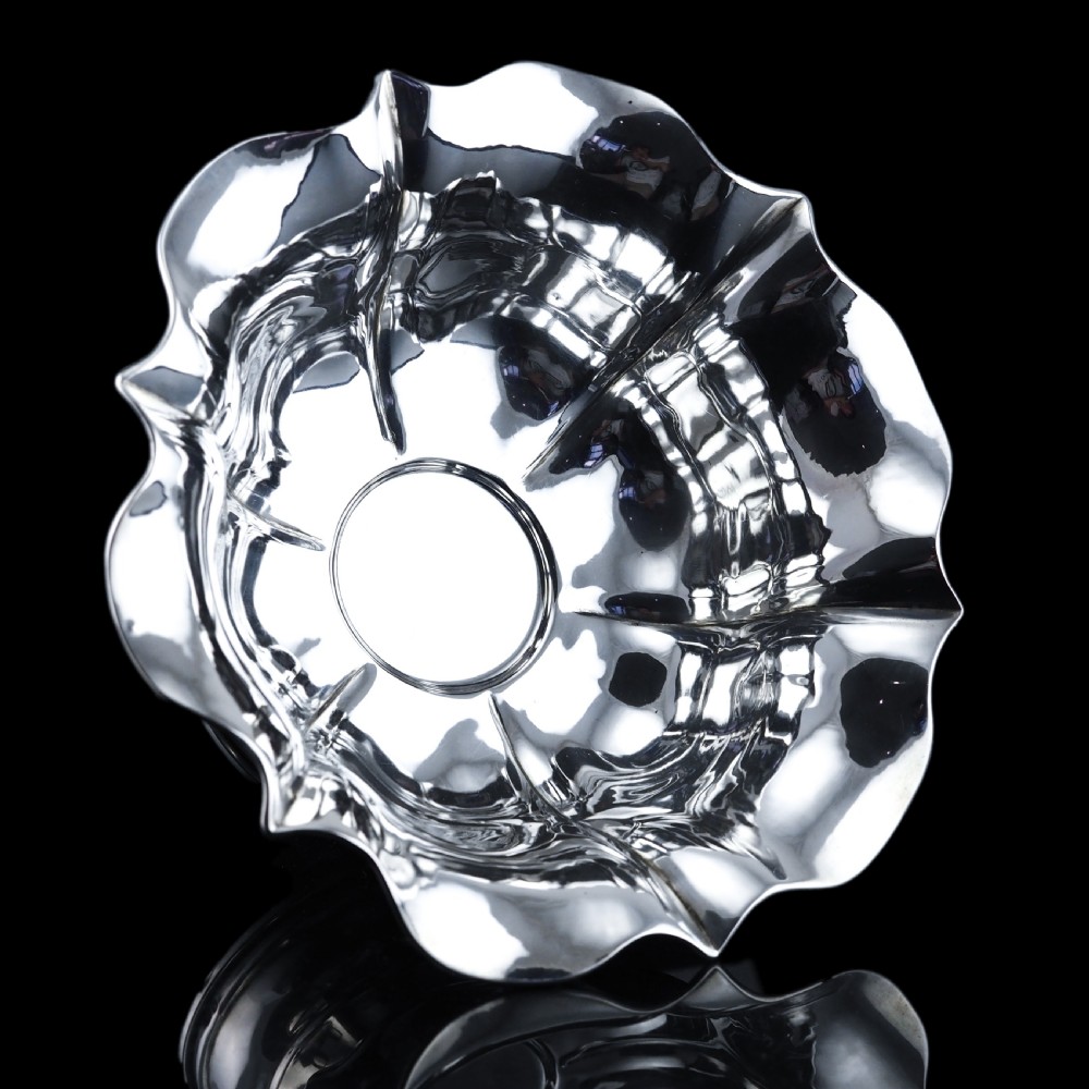 An antique Austro-Hungarian solid silver bowl featuring a flared, scalloped rim reminiscent of a floral blossom with a polished reflective finish.