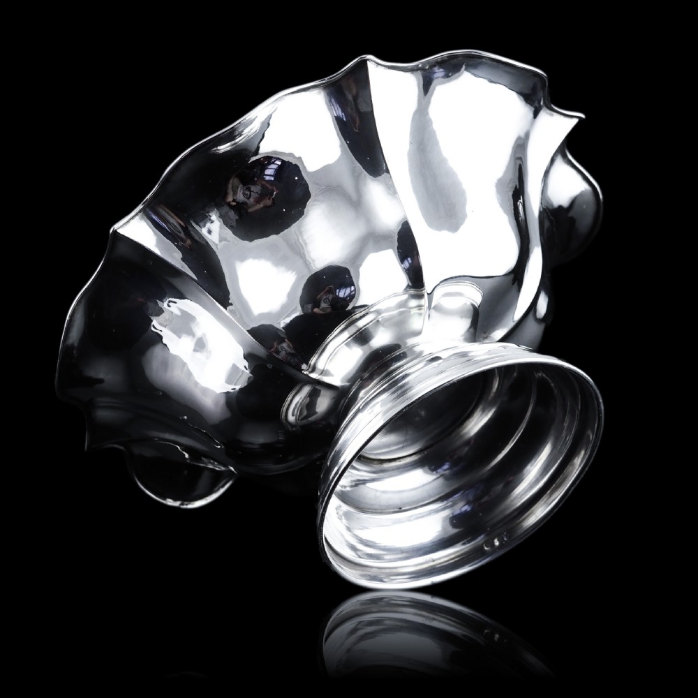 An antique Austro-Hungarian solid silver bowl featuring a flared, scalloped rim reminiscent of a floral blossom with a polished reflective finish. View V