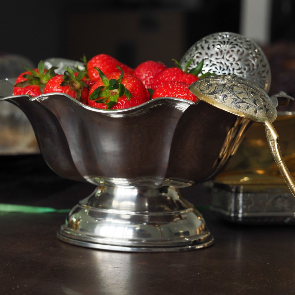 An antique Austro-Hungarian solid silver bowl featuring a flared, scalloped rim reminiscent of a floral blossom with a polished reflective finish. View XV