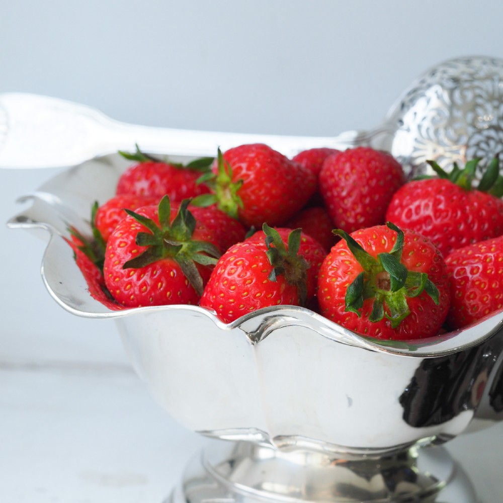 An antique Austro-Hungarian solid silver bowl featuring a flared, scalloped rim reminiscent of a floral blossom with a polished reflective finish. View XVII