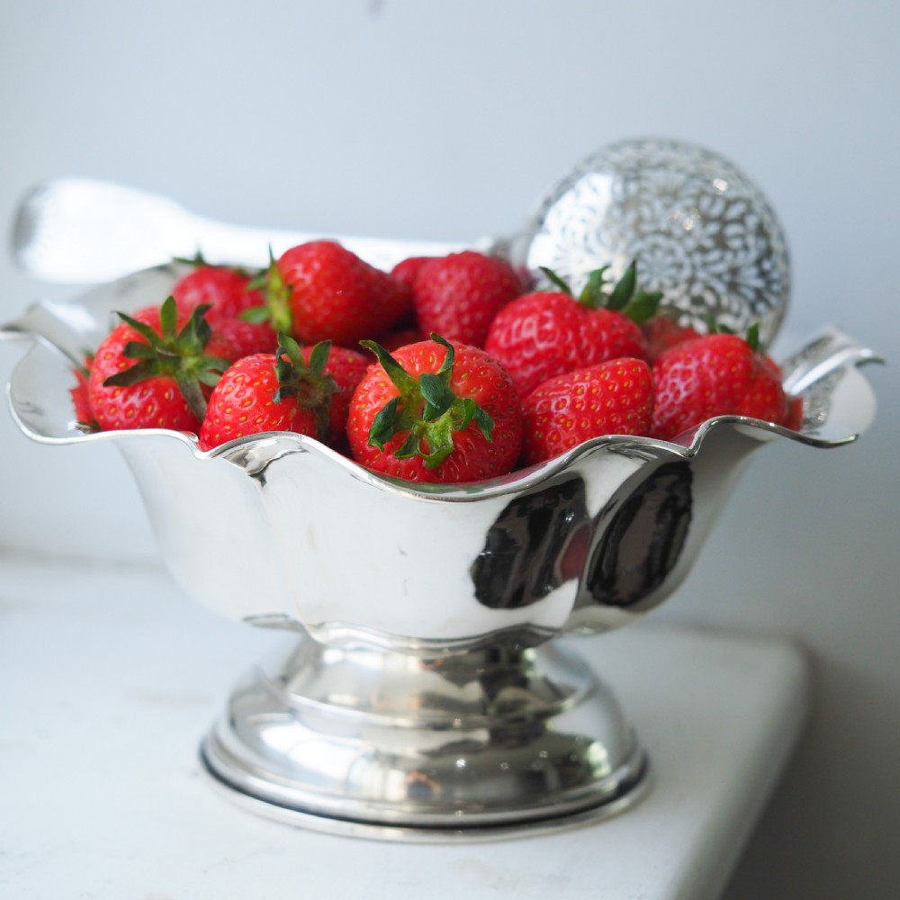 An antique Austro-Hungarian solid silver bowl featuring a flared, scalloped rim reminiscent of a floral blossom with a polished reflective finish. View XIX