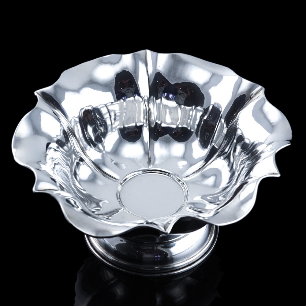 An antique Austro-Hungarian solid silver bowl featuring a flared, scalloped rim reminiscent of a floral blossom with a polished reflective finish. View XX