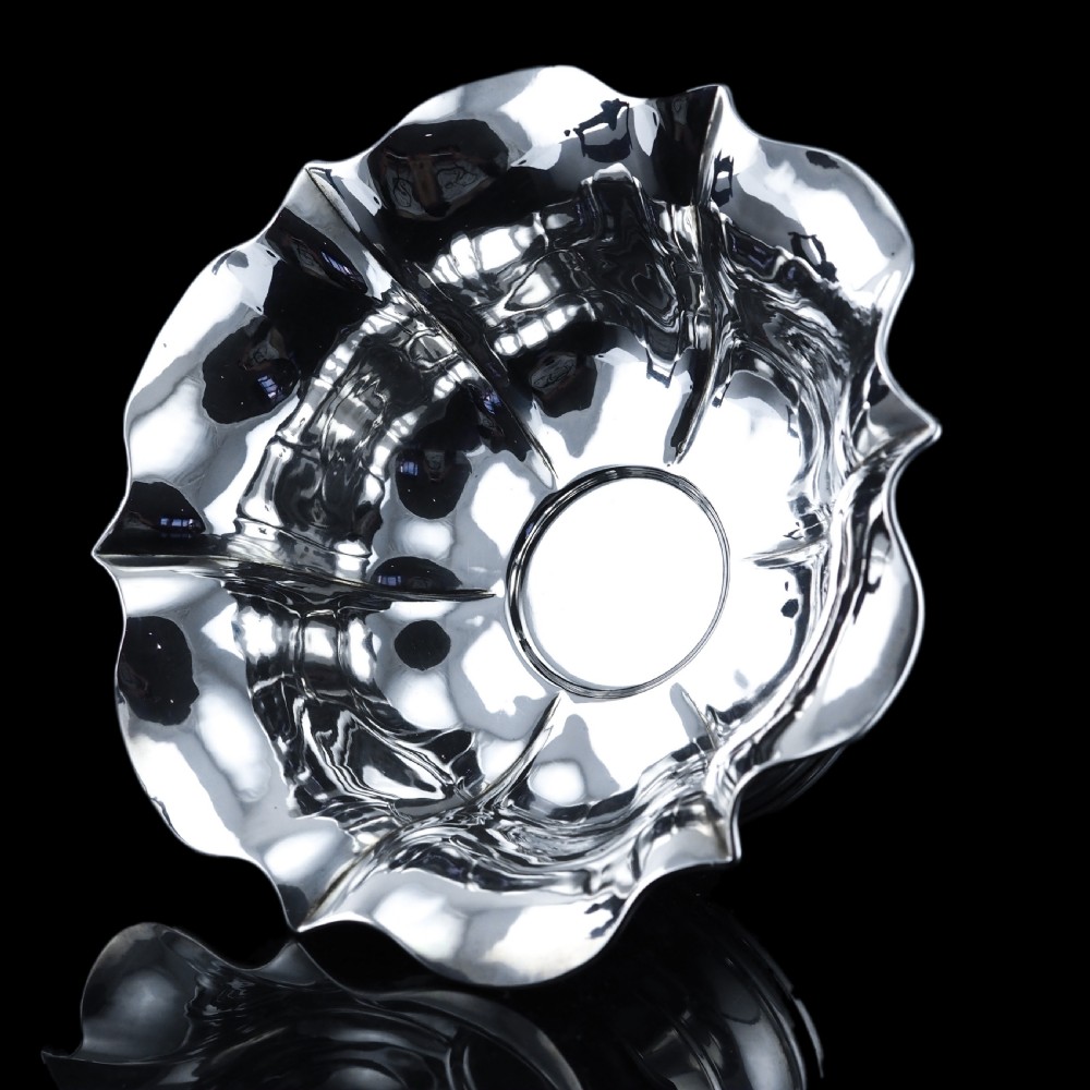 An antique Austro-Hungarian solid silver bowl featuring a flared, scalloped rim reminiscent of a floral blossom with a polished reflective finish. View XXI