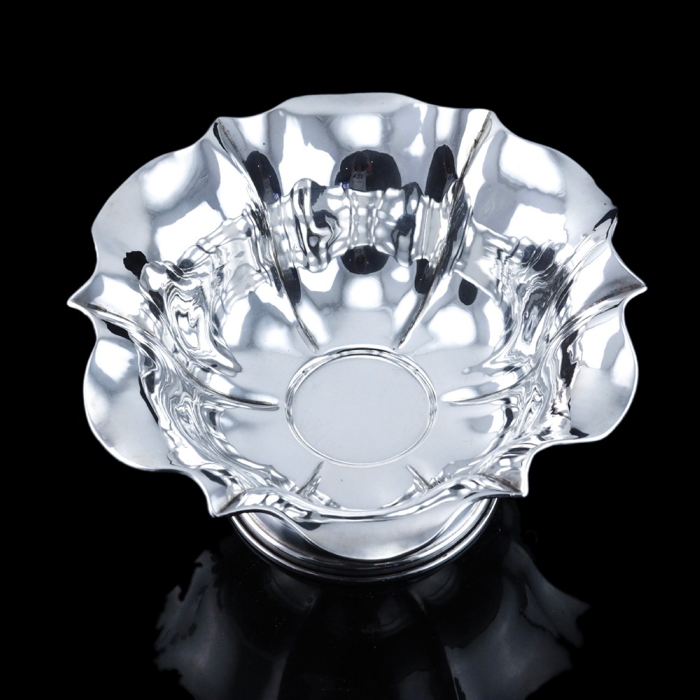 An antique Austro-Hungarian solid silver bowl featuring a flared, scalloped rim reminiscent of a floral blossom with a polished reflective finish. View XXII