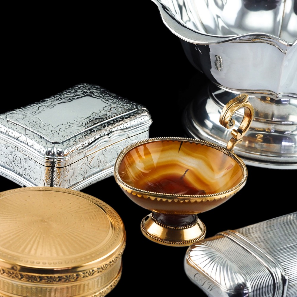 A 19th-century carved brown banded agate cup featuring a silver-gilt rim, pedestal base, and an ornate scroll handle. View VIII