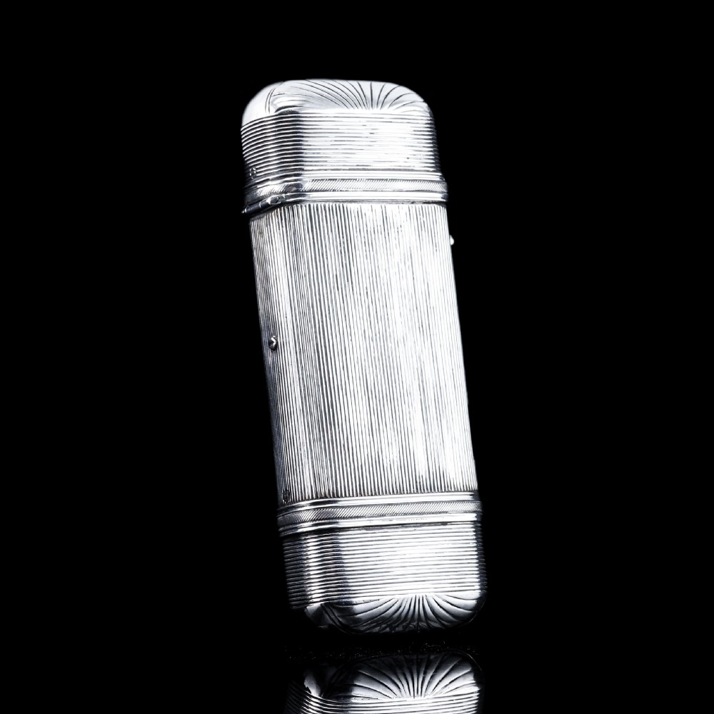 A 19th-century Dutch solid silver cigar case featuring a reeded linear texture and rounded ends with fan-shaped engraving.