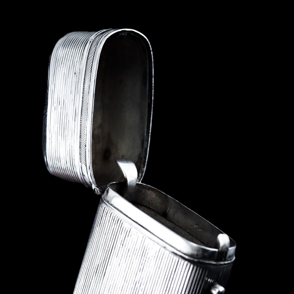 A 19th-century Dutch solid silver cigar case featuring a reeded linear texture and rounded ends with fan-shaped engraving. View II