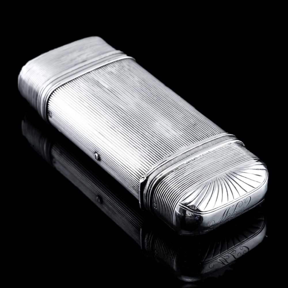 A 19th-century Dutch solid silver cigar case featuring a reeded linear texture and rounded ends with fan-shaped engraving. View III