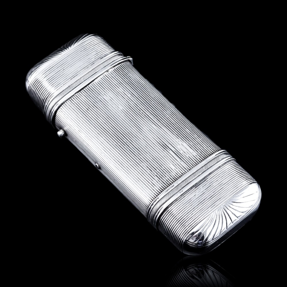 A 19th-century Dutch solid silver cigar case featuring a reeded linear texture and rounded ends with fan-shaped engraving. View V