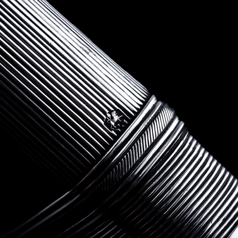 A 19th-century Dutch solid silver cigar case featuring a reeded linear texture and rounded ends with fan-shaped engraving. View XII