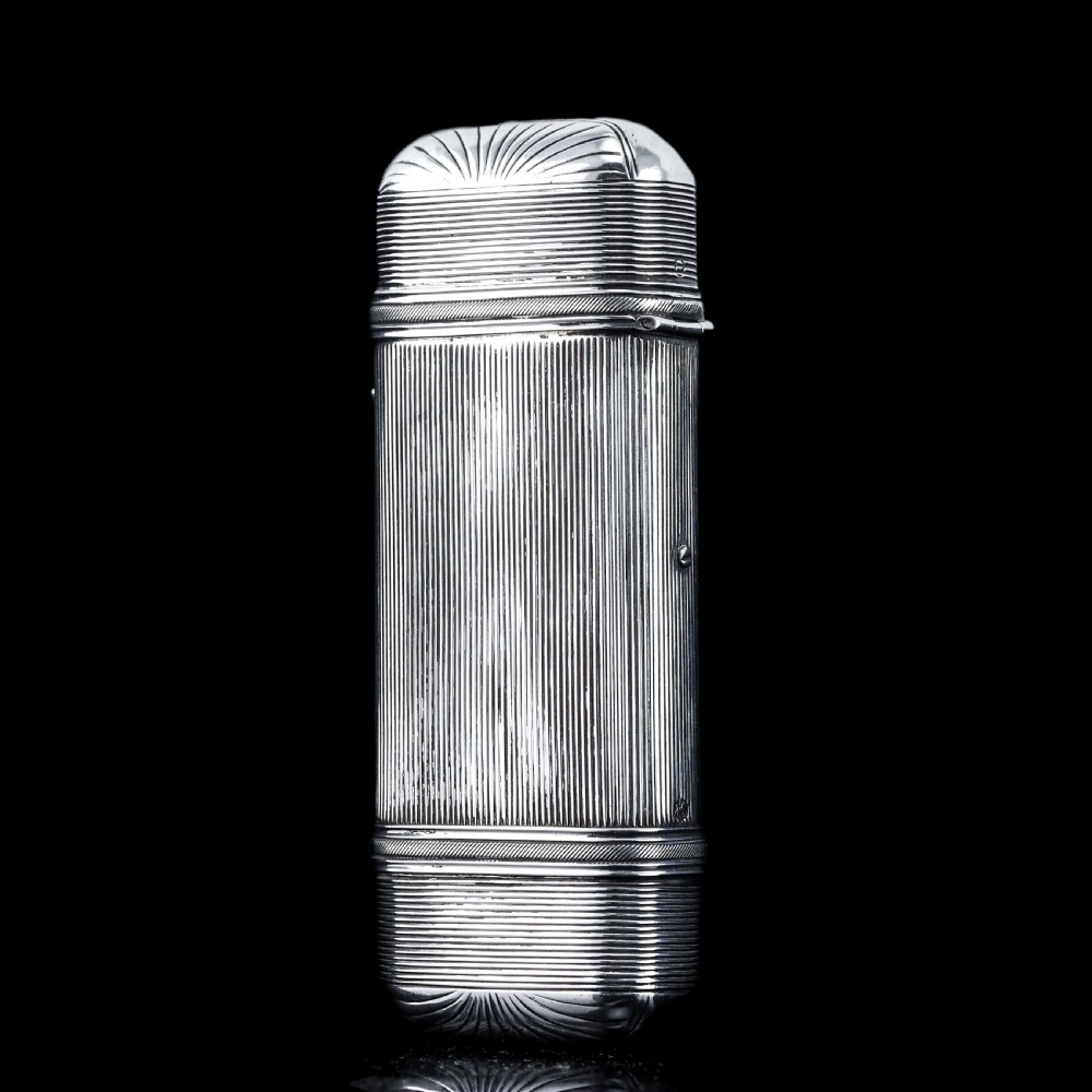 A 19th-century Dutch solid silver cigar case featuring a reeded linear texture and rounded ends with fan-shaped engraving. View XVI