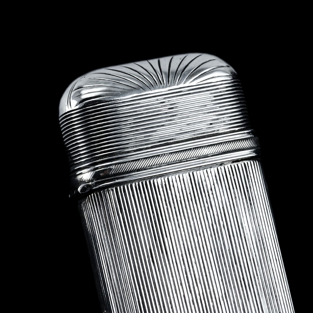 A 19th-century Dutch solid silver cigar case featuring a reeded linear texture and rounded ends with fan-shaped engraving. View XVII