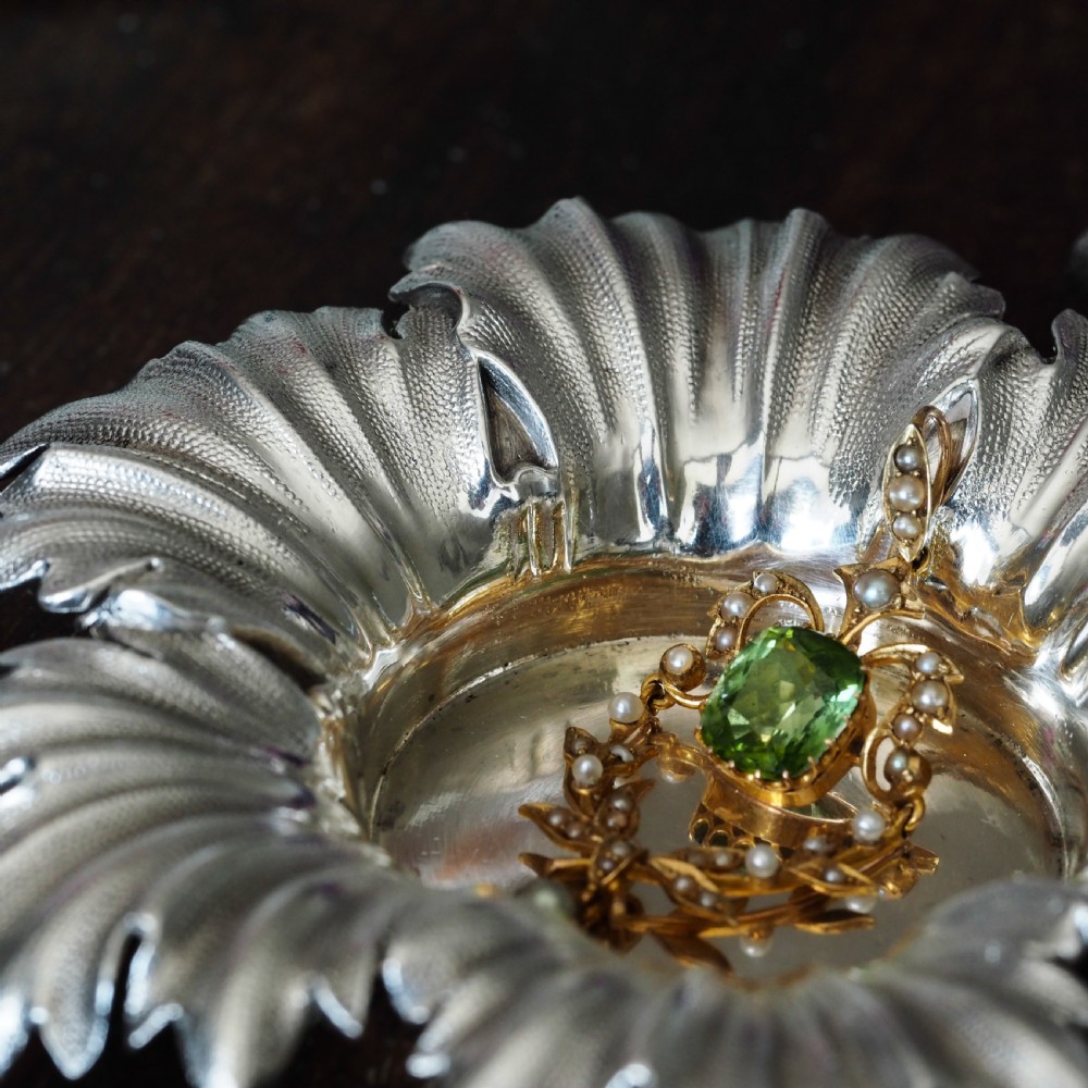 Pair of Victorian sterling silver open salt dishes featuring detailed chased leaf motifs radiating around a central polished circular well. View III
