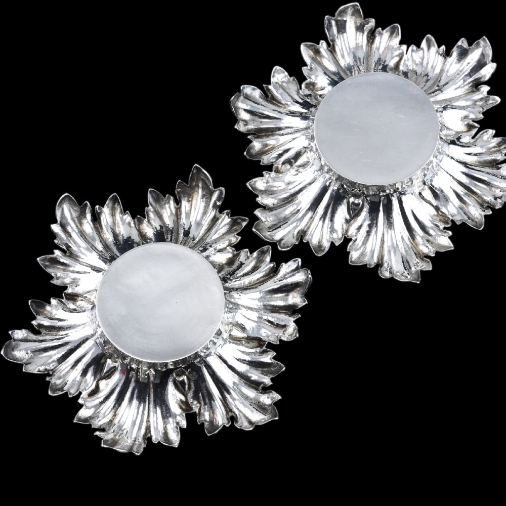 Pair of Victorian sterling silver open salt dishes featuring detailed chased leaf motifs radiating around a central polished circular well. View IX